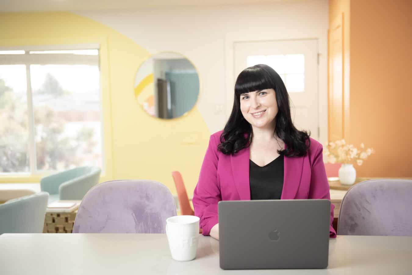 Stacie Dauffenbach, fractional CMO, working at her laptop